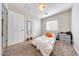Bright bedroom with carpet flooring, a closet, and ample natural light, creating a serene and comfortable retreat at 2716 W Sunland Ave, Phoenix, AZ 85041