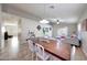 Open floorplan with a dining table set in a large room with a couch and access to the outside at 2716 W Sunland Ave, Phoenix, AZ 85041