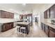 Well-lit kitchen boasts a functional island with bar seating, stainless appliances, and granite countertops at 2716 W Sunland Ave, Phoenix, AZ 85041