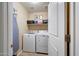 Functional laundry room with washer, dryer, shelving, and ample storage space, conveniently located within the home at 2716 W Sunland Ave, Phoenix, AZ 85041