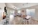 Open living room with tile floors, modern furnishings, and sliding glass doors leading to outdoor space at 2716 W Sunland Ave, Phoenix, AZ 85041