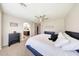 Spacious main bedroom featuring a large bed, neutral decor, and an ensuite bathroom, providing a peaceful retreat at 2716 W Sunland Ave, Phoenix, AZ 85041