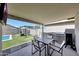 Covered patio featuring an outdoor kitchen, dining area, and view of the backyard pool at 2716 W Sunland Ave, Phoenix, AZ 85041