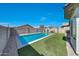 Backyard oasis with a sparkling pool, lush artificial turf, and privacy fencing at 2716 W Sunland Ave, Phoenix, AZ 85041
