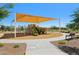 Community playground with a sunshade structure for to enjoy outdoor play at 2948 E Mecklenburg Way, San Tan Valley, AZ 85143