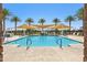 Resort-style community pool area with palm trees, shade sails, lounge chairs, and water play area at 2988 E Mecklenburg Way, San Tan Valley, AZ 85143
