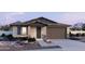 Charming single-story home featuring a two-car garage, stone accents, and a low-maintenance landscaped yard at 2988 E Mecklenburg Way, San Tan Valley, AZ 85143