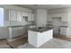 This modern kitchen features white cabinets, granite countertops, and a center island with sink at 2988 E Mecklenburg Way, San Tan Valley, AZ 85143