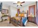 Cozy bedroom featuring a decorative metal bed frame, matching wood furnishings, and natural light at 3214 N 138Th Dr, Avondale, AZ 85392