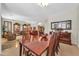 Spacious dining room with large wooden table and chairs, open to the living area at 3214 N 138Th Dr, Avondale, AZ 85392