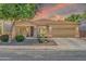 Charming single-story home with stone accents, a well-manicured yard, and a spacious two-car garage at 3214 N 138Th Dr, Avondale, AZ 85392
