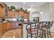 Well-equipped kitchen with wooden cabinets, granite countertops, and stainless steel appliances at 3214 N 138Th Dr, Avondale, AZ 85392