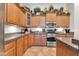 Stylish kitchen with wood cabinets, granite counters, and stainless steel appliances at 3214 N 138Th Dr, Avondale, AZ 85392