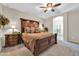 Luxurious main bedroom featuring an ornate wooden bed frame and a ceiling fan at 3214 N 138Th Dr, Avondale, AZ 85392