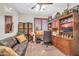 Cozy office space with built-in wooden shelving, desk, and comfortable seating area at 3214 N 138Th Dr, Avondale, AZ 85392