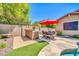 Backyard outdoor kitchen and patio featuring a dining set and a built-in BBQ grill at 3214 N 138Th Dr, Avondale, AZ 85392