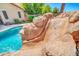 Close-up of the rock waterfall and slide in the backyard pool at 3214 N 138Th Dr, Avondale, AZ 85392