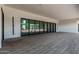 This back porch with wood-look tile is designed with expansive windows to let in lots of natural light at 3653 E Runaway Bay Pl, Queen Creek, AZ 85142
