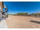 Spacious and modern backyard with a spiral staircase, palm trees, and block wall at 3653 E Runaway Bay Pl, Queen Creek, AZ 85142