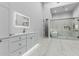 Modern bathroom with marble floors, glass shower, soaker tub, and white cabinetry at 3653 E Runaway Bay Pl, Queen Creek, AZ 85142