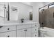 Bathroom featuring white vanity with black fixtures, mirror and tiled shower/tub combo at 3653 E Runaway Bay Pl, Queen Creek, AZ 85142