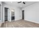 Spacious bedroom with wood-look floors and access to a closet and full ensuite bathroom at 3653 E Runaway Bay Pl, Queen Creek, AZ 85142