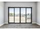Bedroom boasts wood-look flooring and glass sliding doors providing views of the yard at 3653 E Runaway Bay Pl, Queen Creek, AZ 85142
