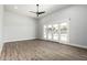 Spacious bedroom features wood floors and large glass doors offering ample natural light at 3653 E Runaway Bay Pl, Queen Creek, AZ 85142