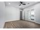 Bright bedroom with wood floors, glass doors, and ceiling fan at 3653 E Runaway Bay Pl, Queen Creek, AZ 85142