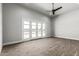 Spacious bedroom featuring wood floors, recessed lighting and large glass doors at 3653 E Runaway Bay Pl, Queen Creek, AZ 85142