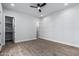 Bright bedroom with wood floors, ceiling fan, and closet at 3653 E Runaway Bay Pl, Queen Creek, AZ 85142