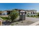 View of a driveway of a modern home with artificial grass and decorative rocks at 3653 E Runaway Bay Pl, Queen Creek, AZ 85142