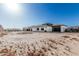 Expansive home exterior showing modern architecture and a large undeveloped backyard at 3653 E Runaway Bay Pl, Queen Creek, AZ 85142