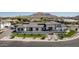 Stunning modern home with clean lines, beautiful landscaping, and a backdrop of majestic mountains at 3653 E Runaway Bay Pl, Queen Creek, AZ 85142