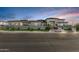 Striking modern home with clean lines, a manicured front yard, and a multi-level roofline against a vibrant sky at 3653 E Runaway Bay Pl, Queen Creek, AZ 85142