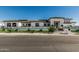 A modern home with a manicured front yard featuring synthetic turf, decorative rocks, and an understated fence at 3653 E Runaway Bay Pl, Queen Creek, AZ 85142