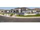 Contemporary home with sleek black accents, manicured green spaces, and elegant landscaping details at 3653 E Runaway Bay Pl, Queen Creek, AZ 85142