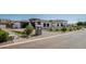 Beautiful home with manicured lawn, modern design, and a paved driveway leading to a spacious garage at 3653 E Runaway Bay Pl, Queen Creek, AZ 85142