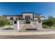 Stunning modern home with a paved pathway leading to the entrance, and well-manicured synthetic turf landscaping at 3653 E Runaway Bay Pl, Queen Creek, AZ 85142