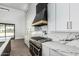 Modern kitchen with an island, marble countertops, stainless steel appliances, and designer fixtures at 3653 E Runaway Bay Pl, Queen Creek, AZ 85142
