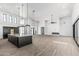 Modern kitchen featuring an island, marble countertops, pendant lighting, and stainless steel appliances at 3653 E Runaway Bay Pl, Queen Creek, AZ 85142