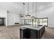 Open concept kitchen with large marble island, and modern pendant lighting at 3653 E Runaway Bay Pl, Queen Creek, AZ 85142