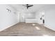 Open living room with wood floors, ceiling fan, and neutral walls at 3653 E Runaway Bay Pl, Queen Creek, AZ 85142