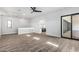 Open-concept living area with wood-look floors, sleek wet bar, and sliding glass doors to outdoor space at 3653 E Runaway Bay Pl, Queen Creek, AZ 85142