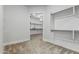 Walk-in closet with carpet flooring, shelving, and door to additional storage space at 3653 E Runaway Bay Pl, Queen Creek, AZ 85142