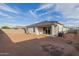 Spacious backyard featuring a patio and ample space for outdoor activities under a bright, sunny sky at 37790 W Santa Clara Ave, Maricopa, AZ 85138