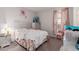 Cozy bedroom with a decorative headboard, a floral comforter, and lots of light at 37790 W Santa Clara Ave, Maricopa, AZ 85138
