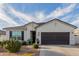 Inviting single-story home featuring a well-maintained front yard and a neutral color scheme at 37790 W Santa Clara Ave, Maricopa, AZ 85138