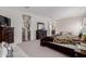 This main bedroom offers a large bed with a seating area, plenty of space, and carpet at 37790 W Santa Clara Ave, Maricopa, AZ 85138