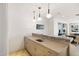 Modern bar area featuring stylish pendant lighting and a sink for entertaining guests at 3801 N Goldwater Blvd # 201, Scottsdale, AZ 85251